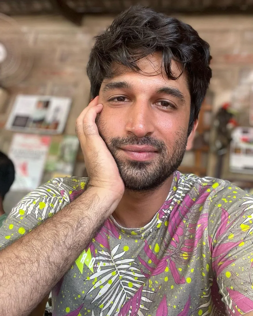 Portrait of Prithvi Dev, resting his cheek on his hand.