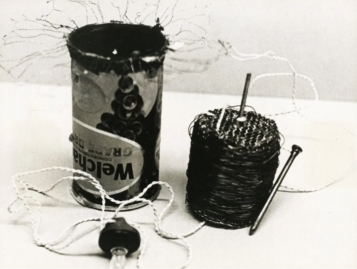 Papanek and Seeger's tin-can radio: a used juice can sprouting wire, beside a wound coil, a nail and an earpiece.